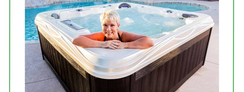 Woman relaxing in Island series hot tub by Artesian Spas